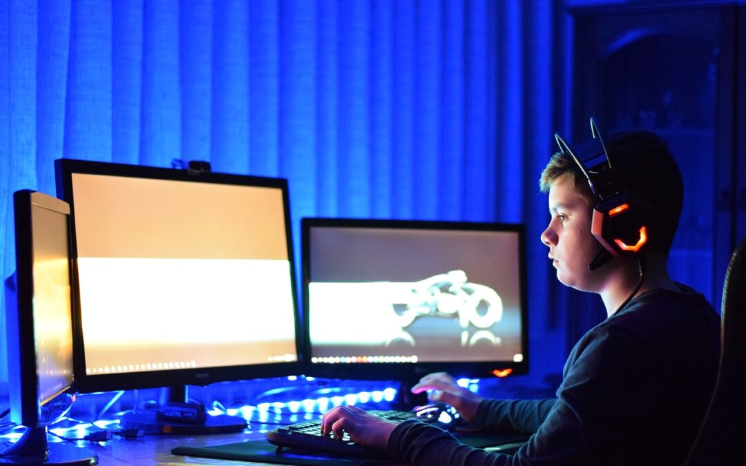 child looking at computer screens